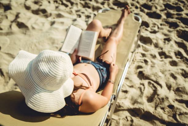 istock Reading on Sunbed at the Seaside 946009314