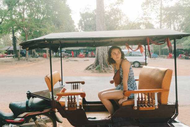 Woman in tuk-tuk   in Angkor Wat  temple Young Caucasian woman in tuk-tuk   in Angkor Wat  temple, Siem Reap, Cambodia khmer stock pictures, royalty-free photos & images