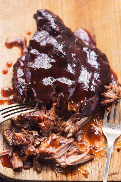 Slow cooked pork shoulder with hoisin glaze Slow cooked pork shoulder with hoisin glaze hoisin sauce stock pictures, royalty-free photos & images