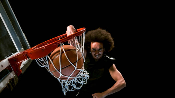 istock Male basketball player doing slam dunk 946017104