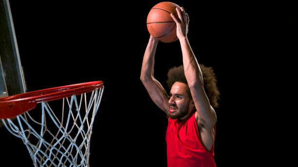 istock Male basketball player doing slam dunk 946017110
