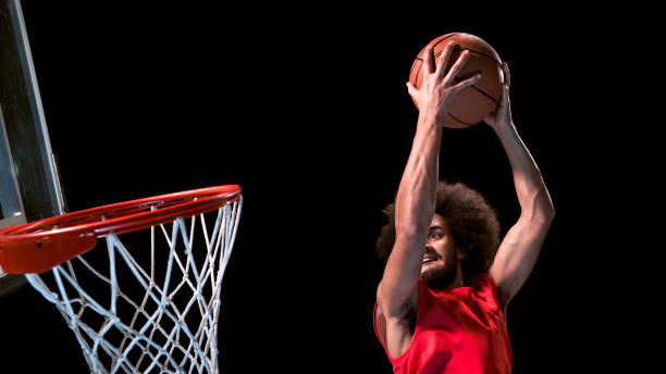 istock Male basketball player doing slam dunk 946017114