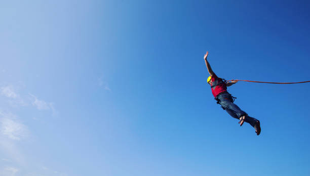 istock Jump off a cliff into a canyon with a rope. 946018316