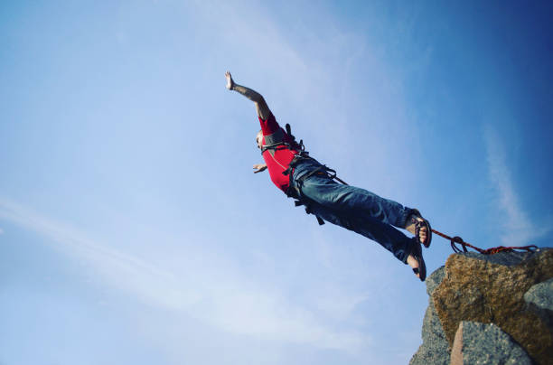 istock Jump off a cliff into a canyon with a rope. 946018318