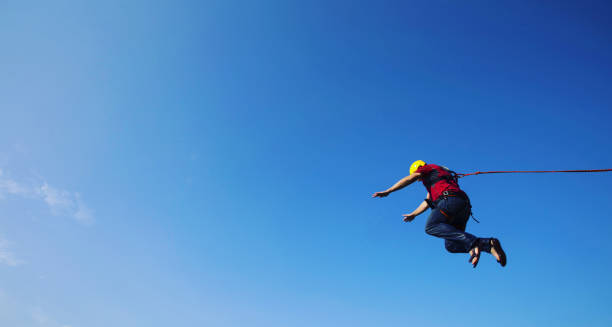 istock Jump off a cliff into a canyon with a rope. 946018324