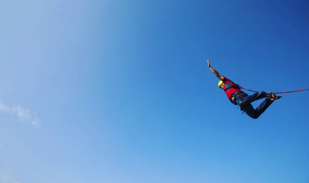 istock Jump off a cliff into a canyon with a rope. 946018346