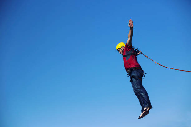istock Jump off a cliff into a canyon with a rope. 946018364