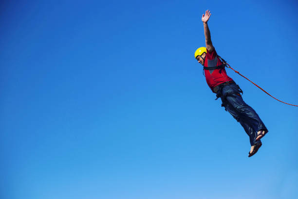 istock Jump off a cliff into a canyon with a rope. 946018386