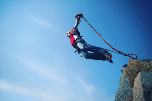 istock Jump off a cliff into a canyon with a rope. 946018390