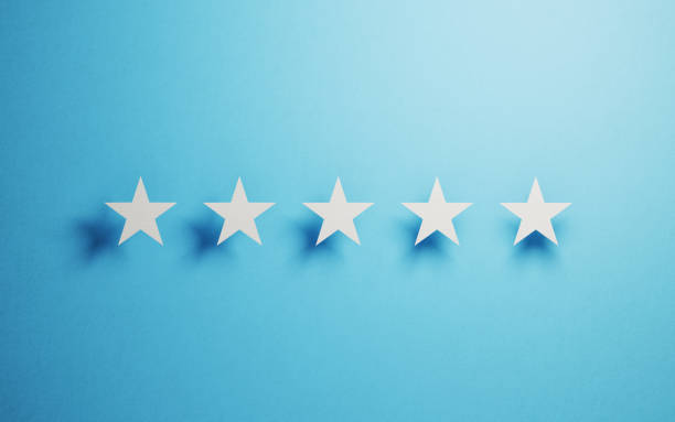 istock Feedback Concept - White Cut Out Star Shapes Over Blue Background 946020792