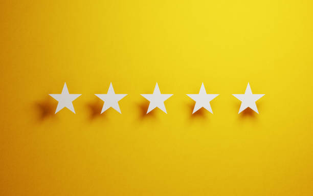istock Feedback Concept - White Cut Out Star Shapes Over Yellow Background 946020974