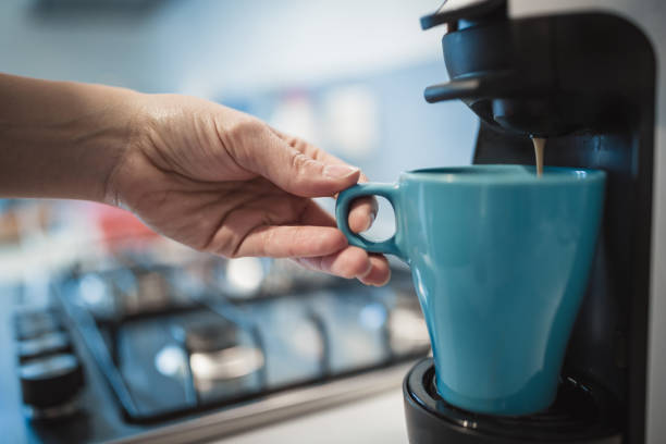 istock Close-up female hands making coffee in kitchen 946022100