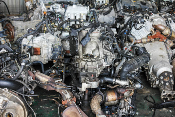 Old and useless auto parts are piled up in the junkyard.