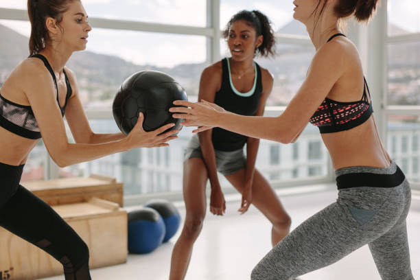 istock Medicine ball passing workout in gym 946028540