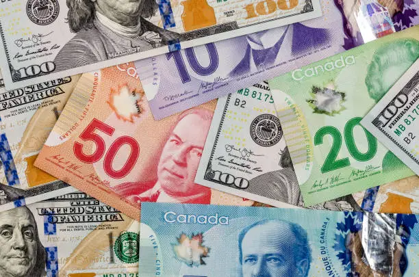 Photo of canadian and american dollar as background