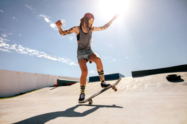 istock Female skater skateboarding at skate park. 946032430