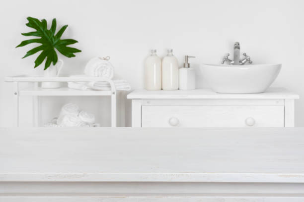 istock Wooden table top with blurred bathroom interior for product display 946035210