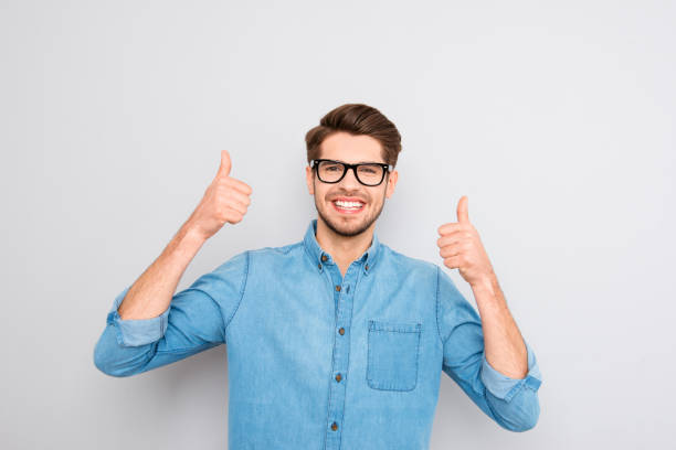 istock Happy smiling man in glasses showing thumbs up 946036344