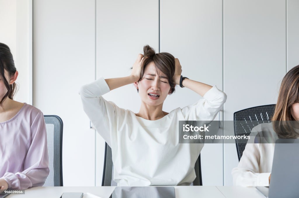 Young woman holding her head. Women Stock Photo