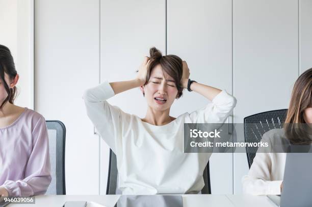 Young Woman Holding Her Head Stock Photo - Download Image Now - Women, Emotional Stress, Worried