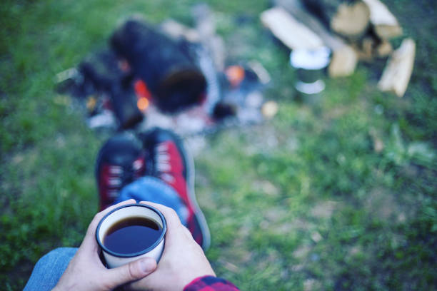 istock A man is preparing breakfast at a fire in the camp. 946039262