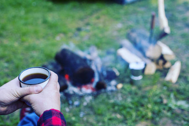 istock A man is preparing breakfast at a fire in the camp. 946039354