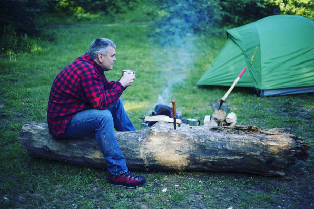 istock A man is preparing breakfast at a fire in the camp. 946039370