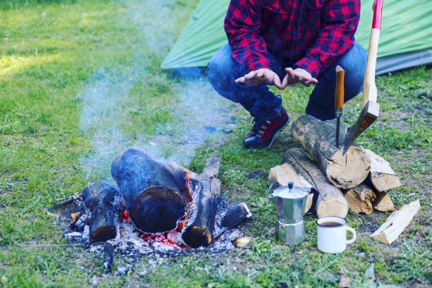 istock A man is preparing breakfast at a fire in the camp. 946039392