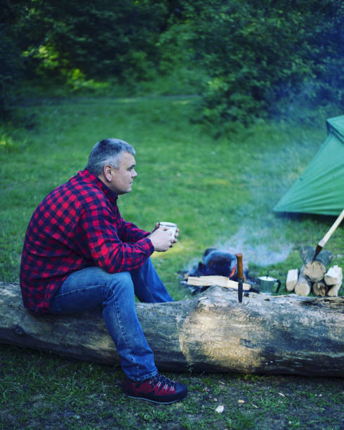 istock A man is preparing breakfast at a fire in the camp. 946039456
