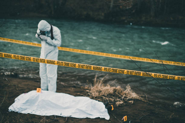istock Forensic pathologist taking photos of evidence 946040084