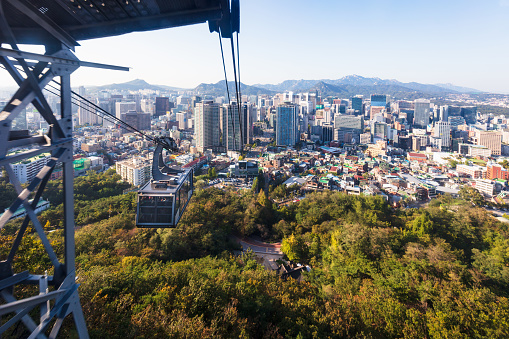 Cable Car from N Seoul Tower to Downtown Seoul City. Seoul Cityscape in the background. Namsan, Seoul, South Korea.