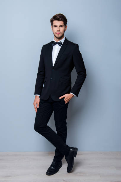 istock Handsome young successful businessman posing in black suit 946042688