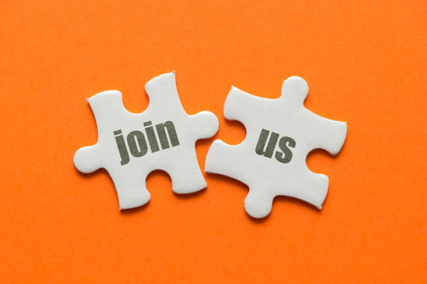 istock The word Join Us! on two matching puzzle on orange background 946044000