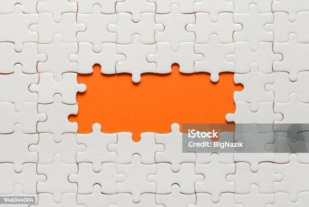 White Details Of Puzzle On Orange Background And Place For Inscription Stock Photo - Download Image Now