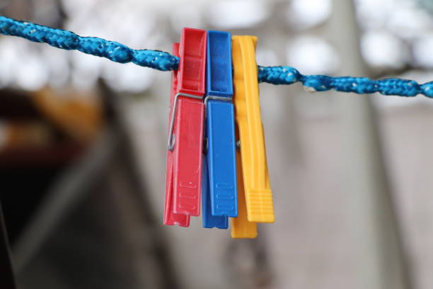 istock Three pegs hunging on blue twine and waiting for a clothes 946044056