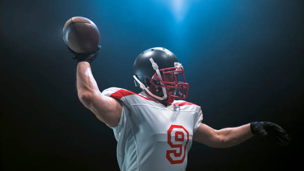istock American football player throwing ball 946046380