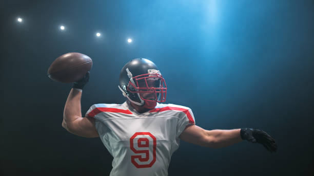istock American football player throwing ball 946046388