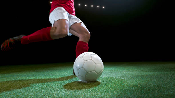 istock Female soccer player kicking the ball 946046392