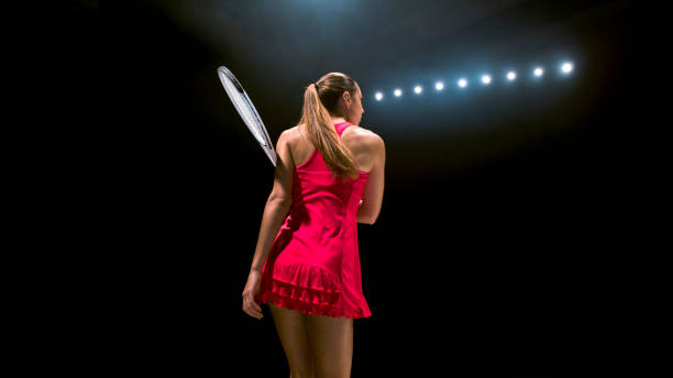 istock Young woman playing tennis 946046404