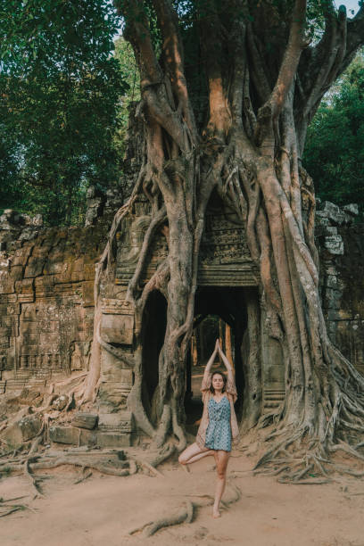 istock Woman doing yoga in   Angkor  temple 946047084