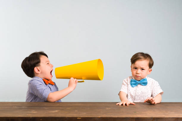 Child is shouting through megaphone to another child