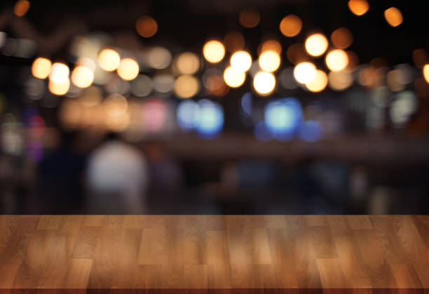 istock Wooden board empty table  cafe, coffee shop, bar blurred background can be used for display or montage your products and Mock up 946051524