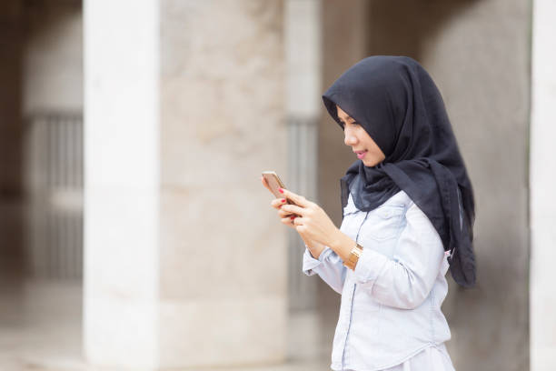 istock Beautiful Muslim woman using a smartphone 946052410
