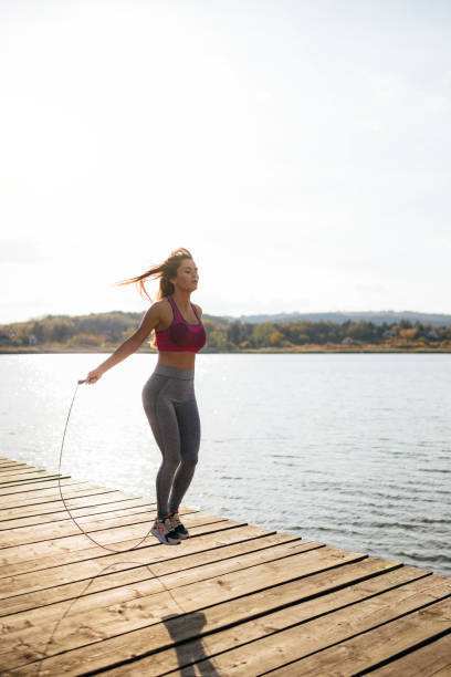 istock Fit young woman skipping a rope 946064476
