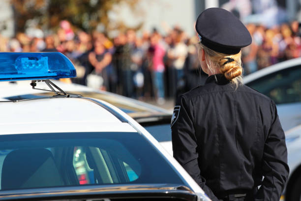 Ukrainian police woman stands beside the patrol car Ukrainian police woman stands beside the patrol car officer military rank stock pictures, royalty-free photos & images