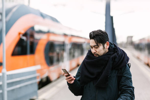 istock Asian commuter looking at the metro timetable 946072922