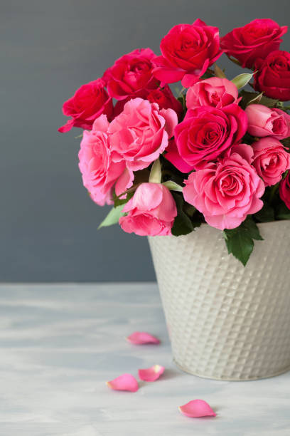 istock beautiful red rose flowers bouquet in vase 946076320
