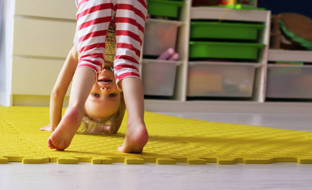 istock Happy cute kid girl practicing yoga and doing exercise 946082840