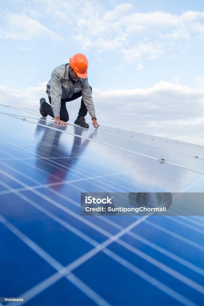 Engineers are checking the electrical system. Selective focus. Engineers and executives are discussing plans. Solar Panel Stock Photo