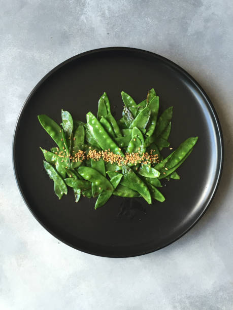 istock Sauteed Sugar Snap Peas on a plate 946086702